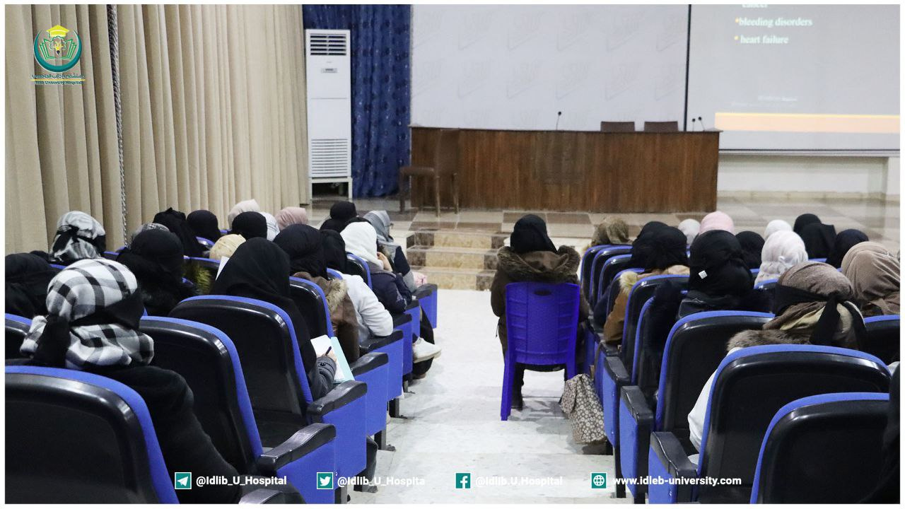 Idlib University Hospital photo of students in the amphitheater’s blue seats, with blue curtains beside the stage.