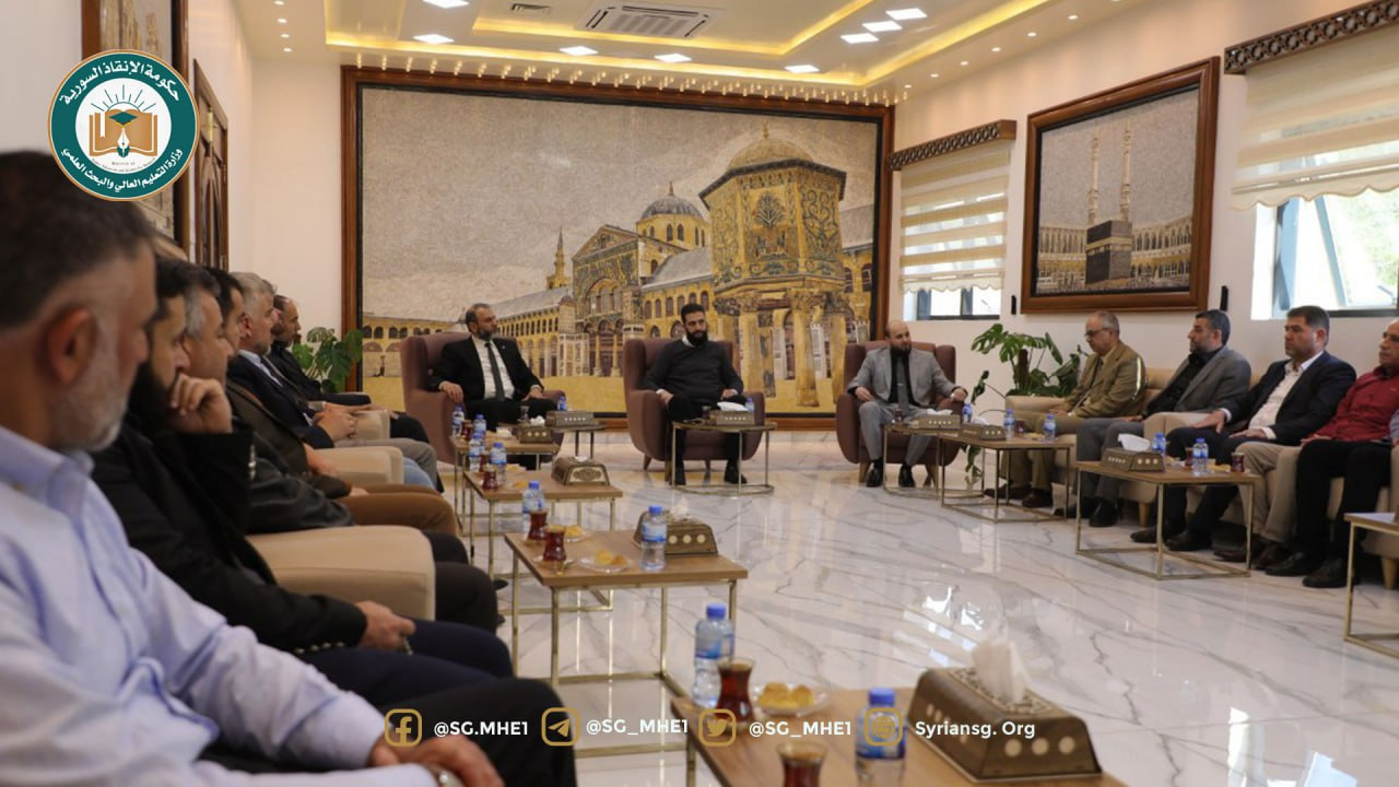 Men seated on sofas in a reception room decorated with a framed painting, April 11, 2024.