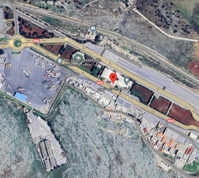Satellite view of a building at the Bab al-Hawa crossing marked with a red pin.